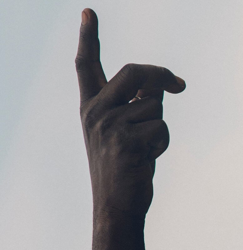 a finger in the air to stop people talking when not understood