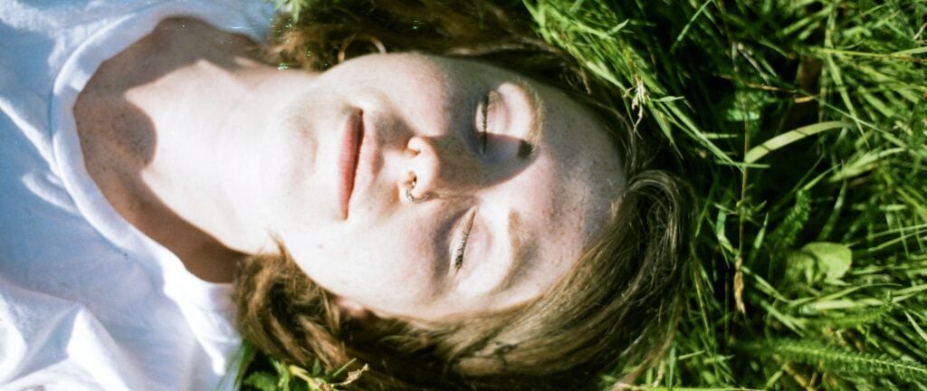 Woman sleeping on grass